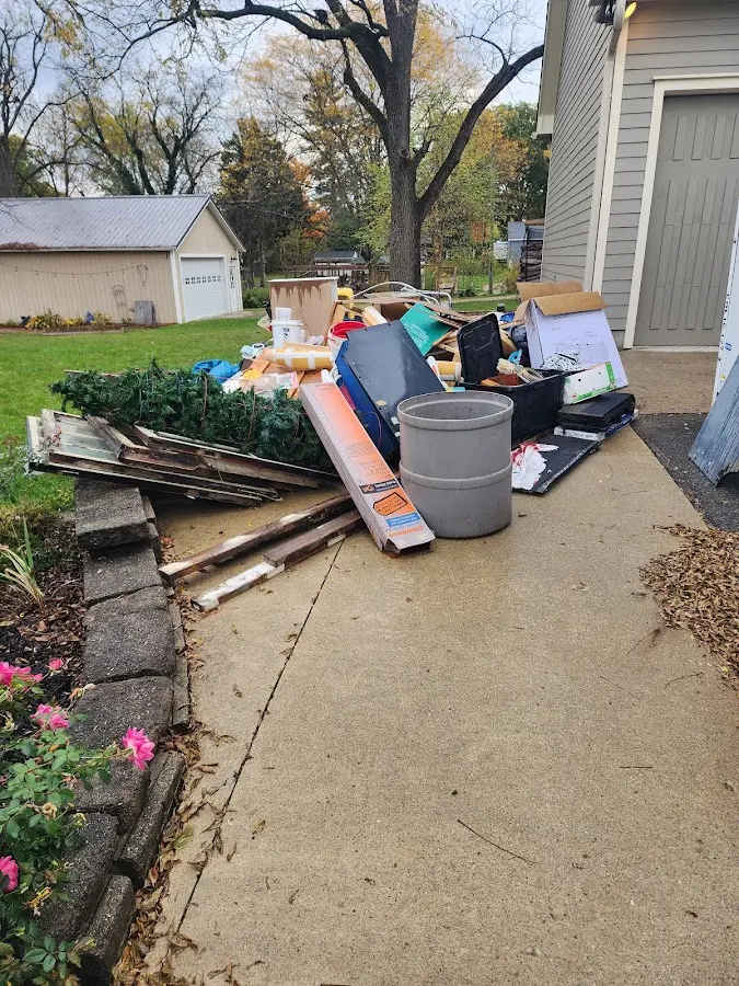 Dumpster being loaded with debris for 12 Yard Dumpster Rental in Lake Bluff